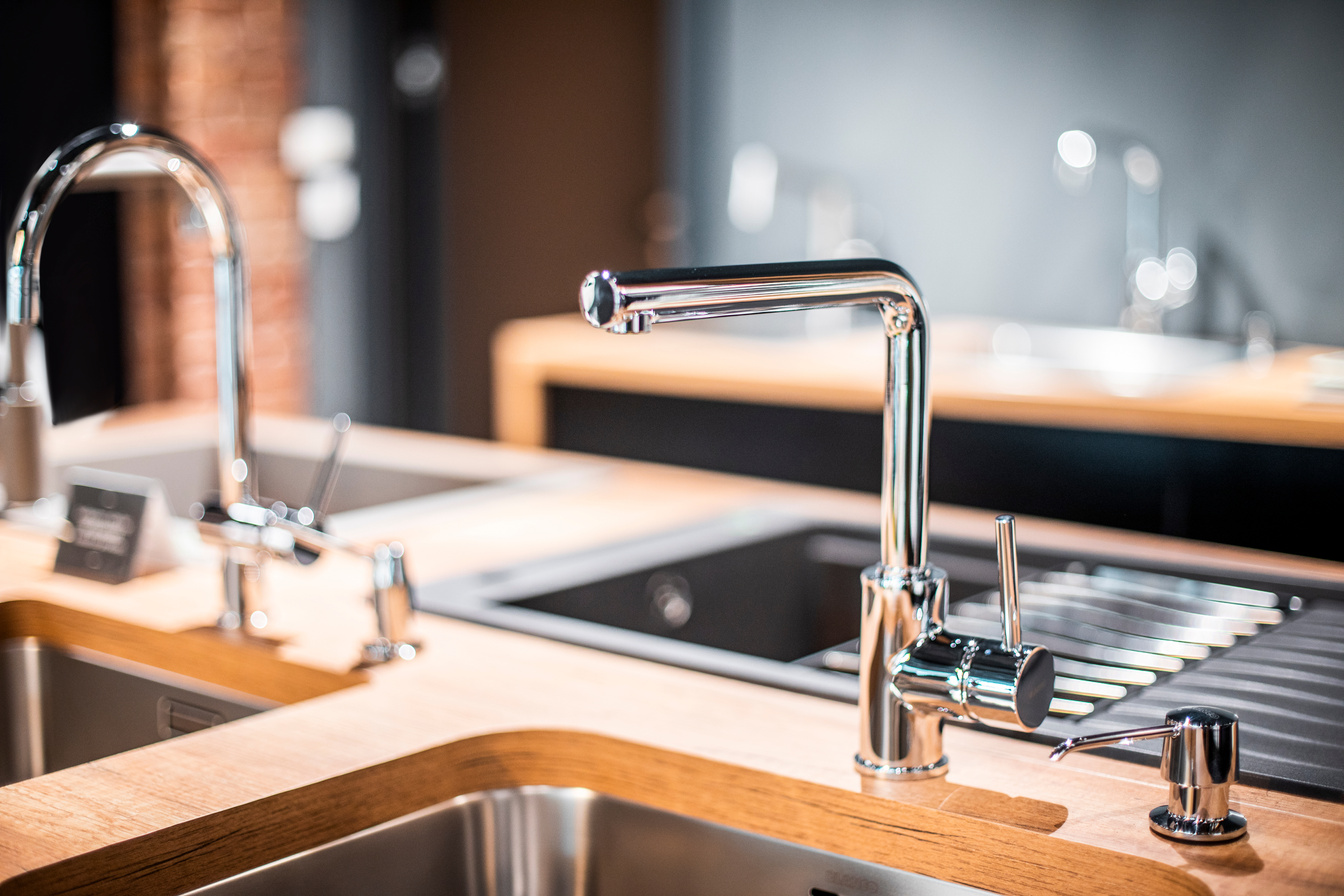 A kitchen dishwashing sink faucet